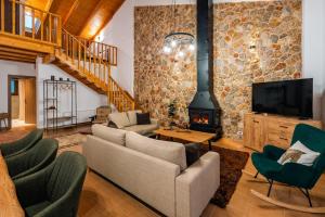 a living room with a couch and a fireplace at Epi tis Stigos in Kalavrita