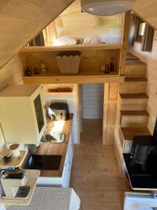 a tiny house with a desk and a computer in it at Tiny House chez Annette in Darvoy +12 photos