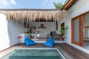 a villa with a swimming pool and a house at NEW Sawah Escape - Tropical 2BR with Pool and Views in Tabanan