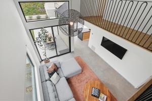 an overhead view of a living room with a couch and a table at Modern Encinitas Retreat in Encinitas