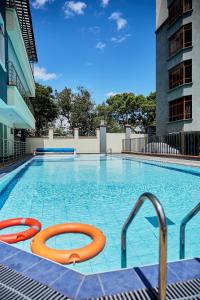 a large swimming pool with two orange tubes in it at Lakeview 3Bedroom Condo with heated pool in Nakuru Town in Nakuru