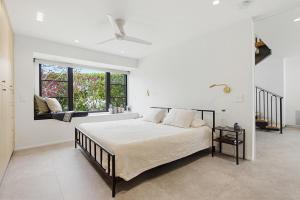 a bedroom with a large bed and a window at Modern Encinitas Retreat in Encinitas +33 photos