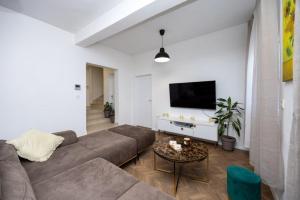 a living room with a couch and a table at Lux suite in Split- Jacuzzi&Gym&more in Solin