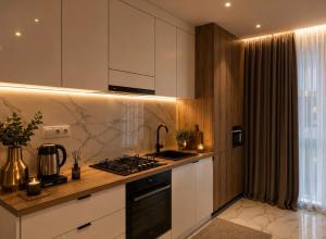 a kitchen with white cabinets and a stove top oven at Апартаменти VIP in Ternopil