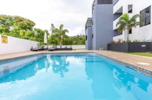 a swimming pool in front of a building at Luxury Bliss in Runaway Bay