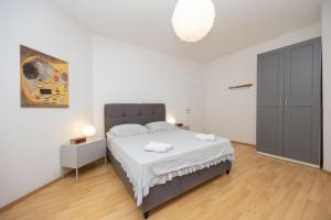 a bedroom with a large bed with two towels on it at Lux suite in Split- Jacuzzi&Gym&more in Solin