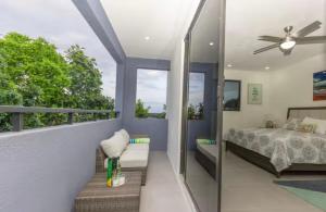 a bedroom with a bed and a balcony at Luxury Bliss in Runaway Bay +19 photos