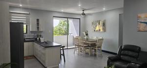a kitchen and dining room with a table and chairs at Luxury Bliss in Runaway Bay