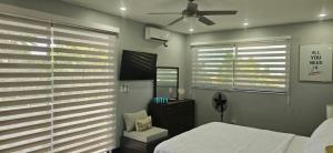 a bedroom with a bed and a ceiling fan at Luxury Bliss in Runaway Bay