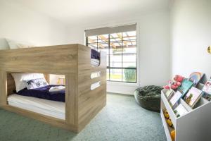 a bedroom with a wooden bed in a room at Nautilus Nest - Port Sorell in Port Sorell
