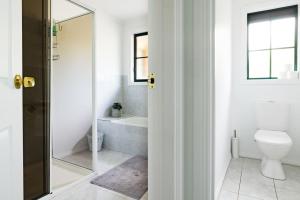 a bathroom with a toilet and a bath tub at Nautilus Nest - Port Sorell in Port Sorell +27 photos