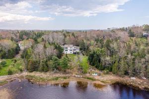 an aerial view of a house on an island in the water at Oceanfront House Steps to Water in French Village