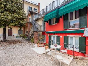 a patio with a table and chairs in front of a building at Corte Magnolia Terme & Lago di Garda in Colà di Lazise