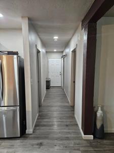 an empty hallway of a room with a refrigerator at Lil Blue Dog Haven in Sagle +42 photos