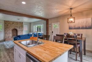 a kitchen and living room with a sink and a table at Lil Blue Dog Haven in Sagle