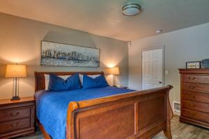 a bedroom with a bed with blue sheets and blue pillows at Lil Blue Dog Haven in Sagle