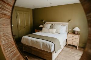 a bedroom with a large bed and a mirror at The Bubble at Stenson in Stanton