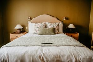 a bedroom with a large white bed with pillows at The Bubble at Stenson in Stanton