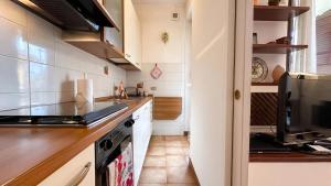 a kitchen with a stove and a counter top at [10 minuti dall'aeroporto] Linate Studio Flat in Peschiera Borromeo +8 photos