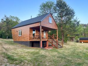 a large wooden house with a gambrel roof at Serce Puszczy in Drawsko