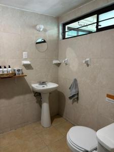 a bathroom with a toilet and a sink at Hostel Casa Maguey in Oaxaca City +46 photos