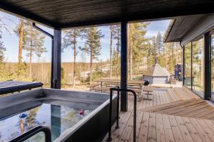 a house in the woods with a pool at Stay North - Villa Mono in Pälkäne