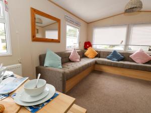 a living room with a couch with pillows on it at Foxglove 4 in Ringwood