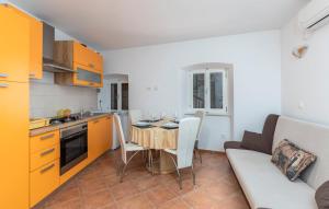 a kitchen and dining room with a table and a couch at Apartment old Town in Lovran