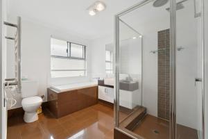 a bathroom with a shower and a toilet and a sink at The Grand Aveley House in The Vines +30 photos