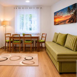a living room with a table and a couch at Zaga Bloom Apartment in Banja Koviljača