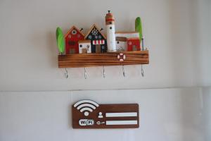 a wooden shelf on a wall with houses and a heater at Tran Phu Riverside House in Can Tho +110 photos