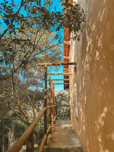 a stairway leading up to a building with a tree at Girassóis do Vale - Chalés no Vale do Capão in Caeté-Açu +35 photos