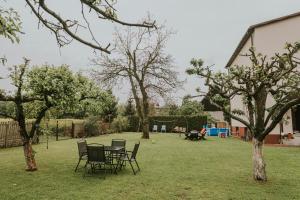 a yard with chairs and a table and trees at Cztery Kąty Zator Energylandia Przeciszów in Przeciszów