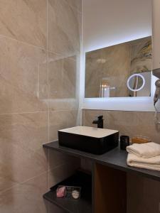 a bathroom with a black sink and a mirror at 103 - Voiron centre - DeTassigny in Voiron