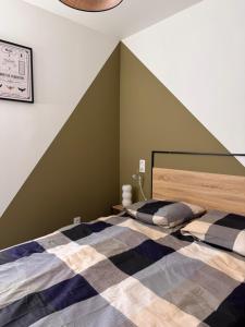 two beds in a bedroom with a striped wall at 103 - Voiron centre - DeTassigny in Voiron