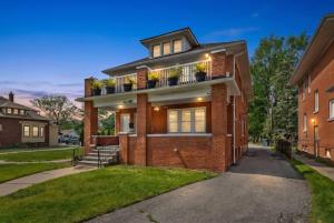 a brick house with potted plants on it at 2 BR - Fully Equipped Dearborn Home in Dearborn