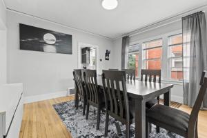 a dining room with a table and chairs at 2 BR - Fully Equipped Dearborn Home in Dearborn