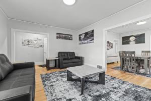 a living room with a couch and a table at 2 BR - Fully Equipped Dearborn Home in Dearborn