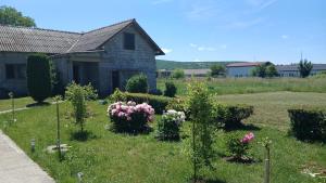 a garden with flowers in front of a house at Zgona in Livno