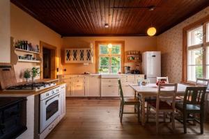 a kitchen with a table and a stove top oven at Stay North - Mustio in Inkoo