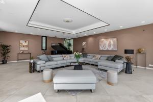 a large living room with couches and a piano at Villa Paradise in Éze