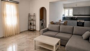 a living room with a couch and a table at Azalea Guesthouse in Andros