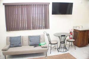 a living room with a couch and a table at The Vista Inn Studio #4 in Falmouth