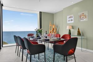 a dining room with a table and chairs at Villa Paradise in Éze