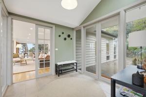 a home office with sliding glass doors and a patio at Bush Escape with Water Views in Tinderbox +35 photos