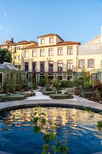a large pool in front of a building at chic&basic Tokyo Hoose in Porto