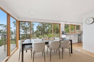 a kitchen and dining room with a table and chairs at Bush Escape with Water Views in Tinderbox