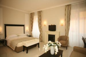 a bedroom with a bed and a living room at Hotel Miramare & Spa in Sestri Levante