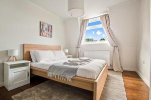 a bedroom with a bed and a large window at Smart TV, Nespresso machine, Self Check-In in Potter Street