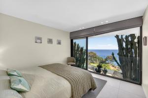 a bedroom with a bed and a large window at Villa Paradise in Éze +130 photos